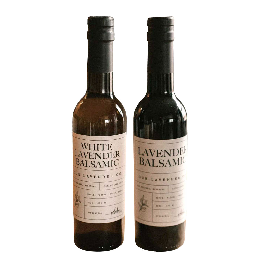 Two bottles of lavender balsamic vinegar on a white background