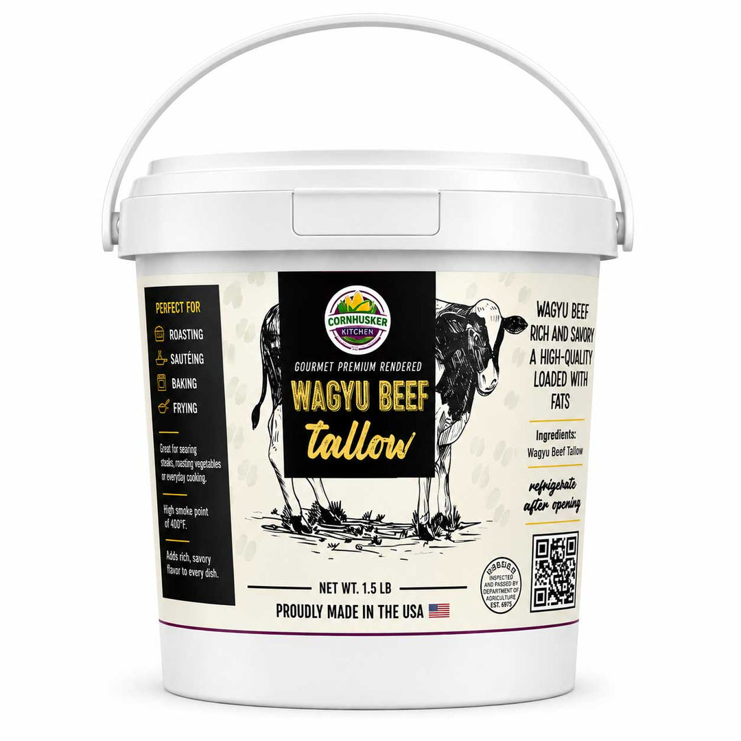 A white plastic bucket of Cornhusker Kitchen Wagyu Beef Tallow with a white handle, featuring a detailed label with a black and white steer illustration and product details.