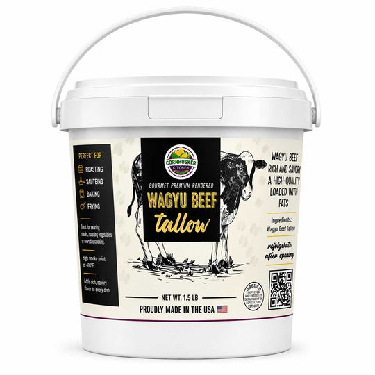 A white plastic bucket of Cornhusker Kitchen Wagyu Beef Tallow with a white handle, featuring a detailed label with a black and white steer illustration and product details.