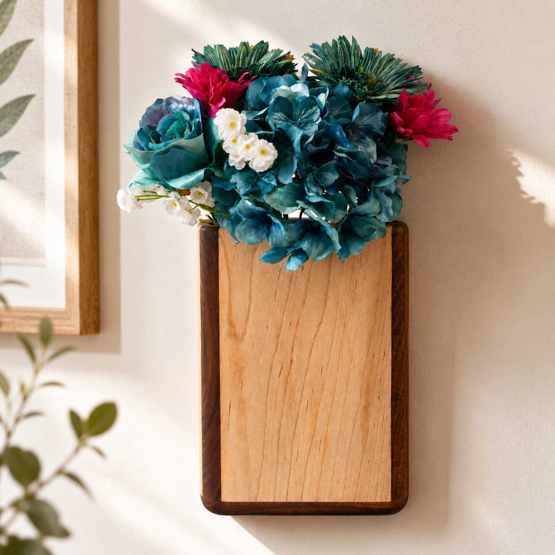 Wooden wall planter with colorful flowers on a neutral wall