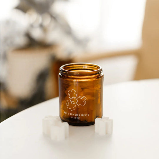 Brown glass jar with a logo on a white surface