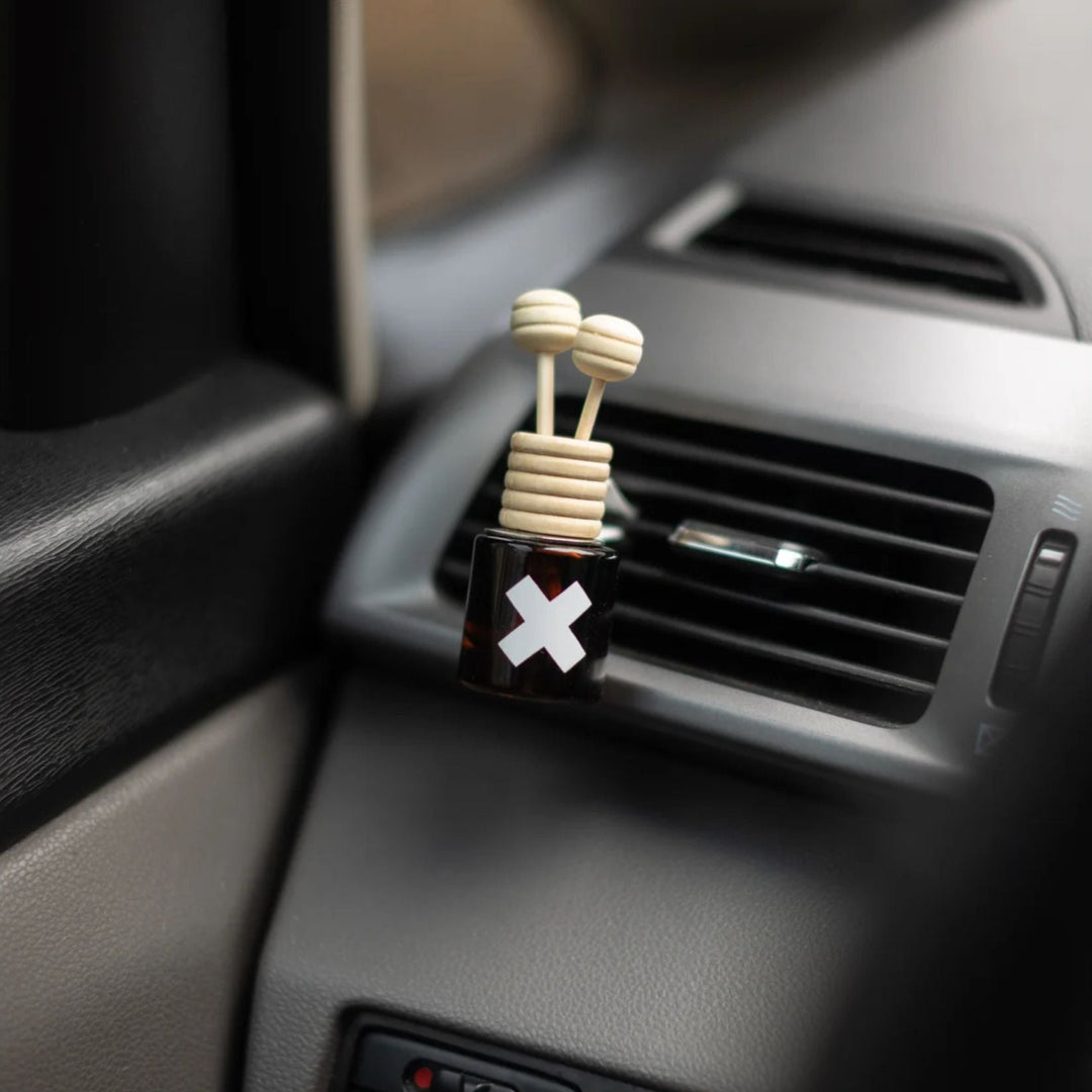 Car air freshener with a unique design on a car dashboard.