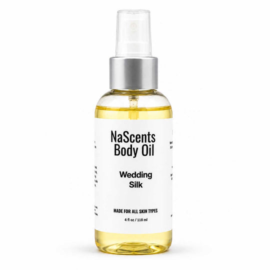 A bottle of NaScents Body Oil in the Wedding Silk scent, featuring a clear spray top, silver collar, and a white label with black text, set against a plain white background.