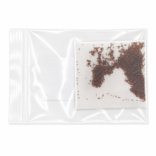 Clear plastic bag with a small amount of brown seeds on a white background