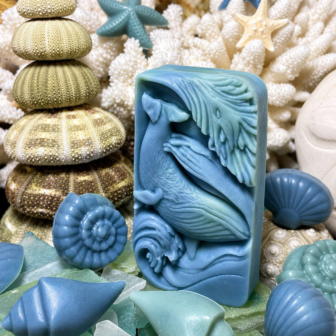 Blue silicone mold shaped like a whale surrounded by sea-themed decorations