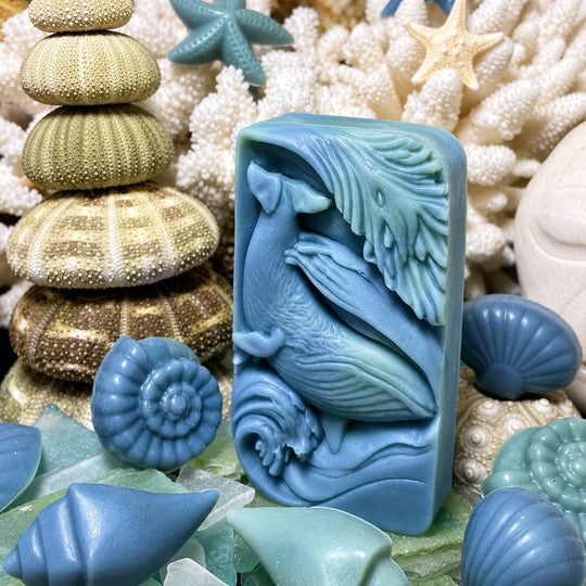 Blue silicone mold shaped like a whale surrounded by sea-themed decorations