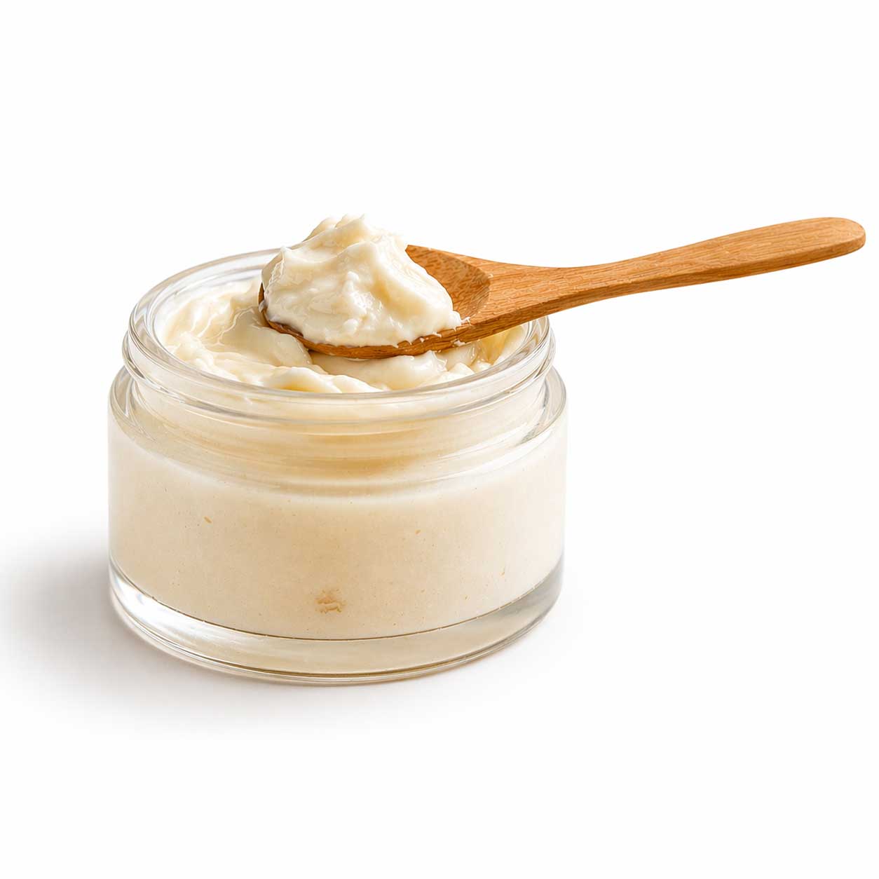 Jar of cream with a wooden spoon on a white background