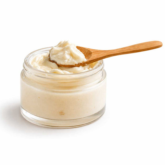 Jar of cream with a wooden spoon on a white background