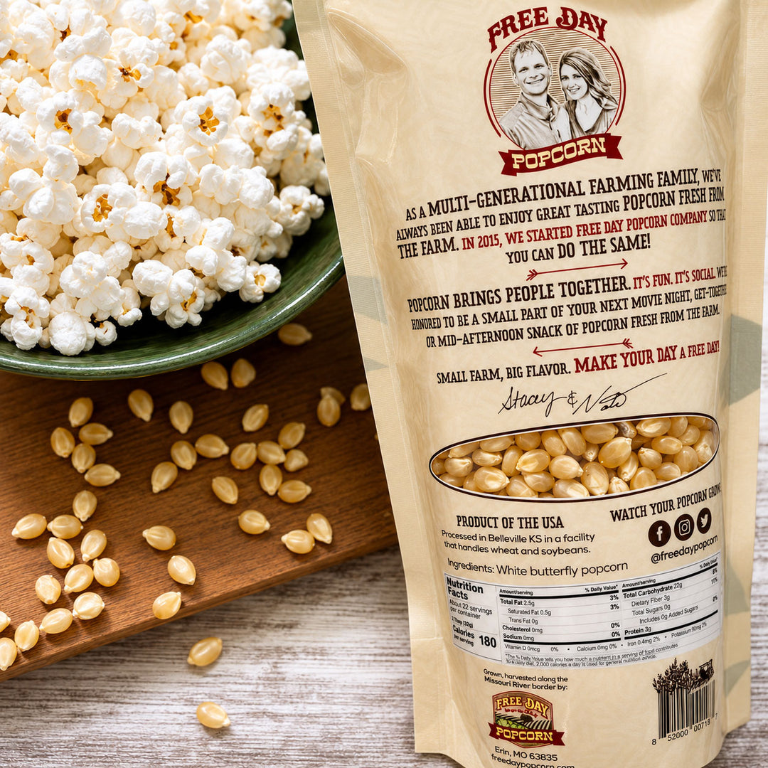 Free Day Popcorn bag with popcorn and kernels on a wooden surface