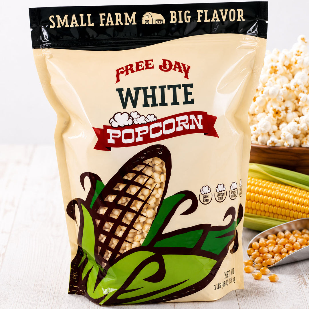 Bag of Free Day White Popcorn with corn and popcorn kernels on a wooden surface