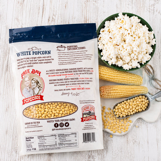 Freddie's Popcorn package with popcorn, corn, and a bowl of popped popcorn on a wooden surface.