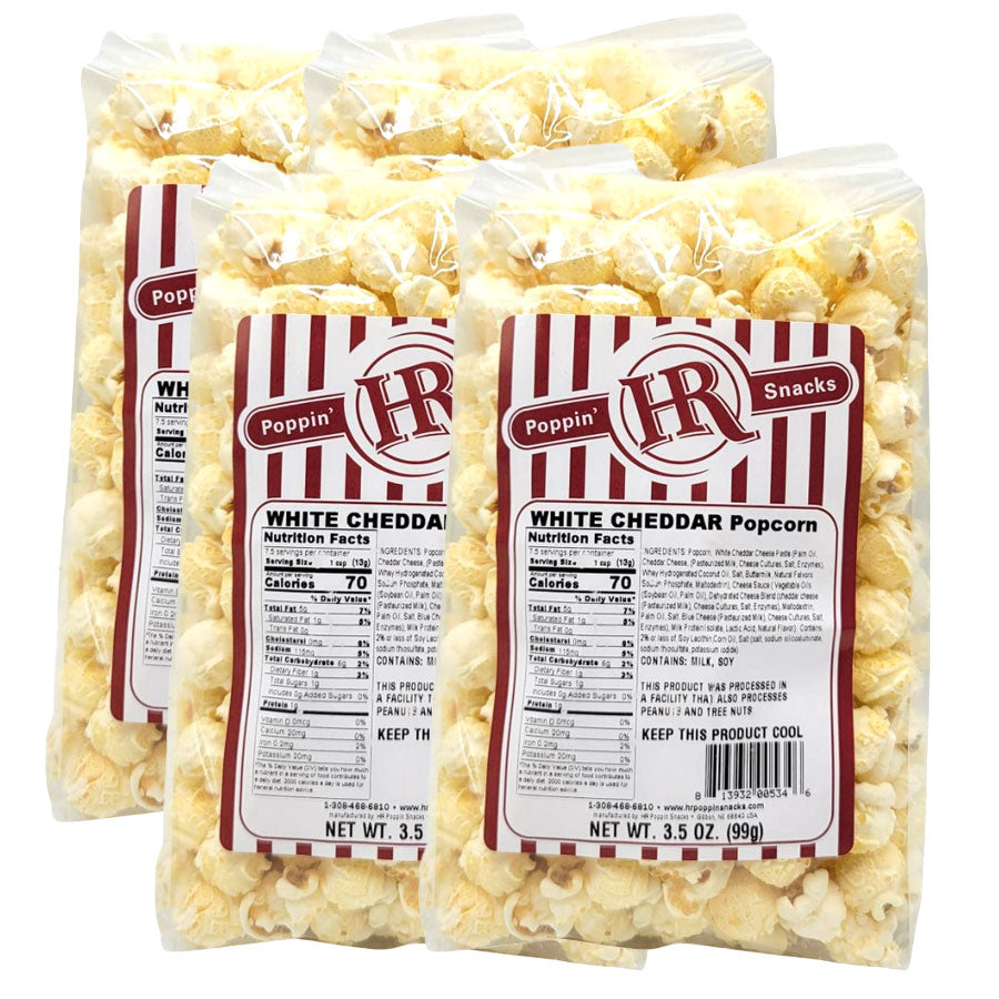 Four bags of Poppin' Hot White Cheddar popcorn with labels on a white background
