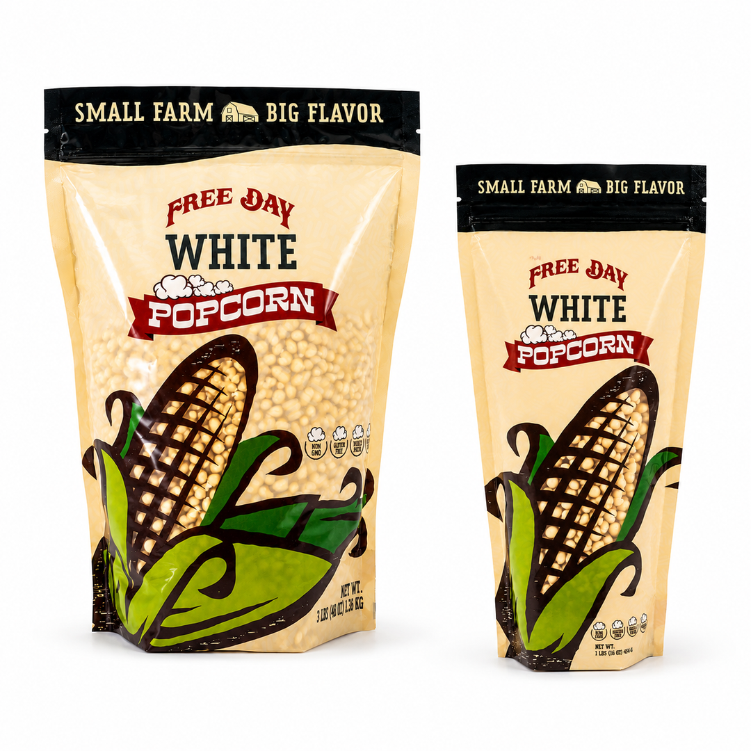 Two packages of Free Day White Popcorn on a white background
