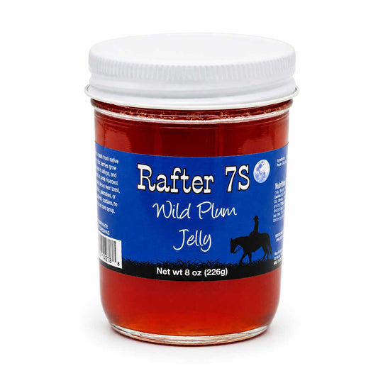 Jar of Rafter 7S Wild Plum Jelly with a blue label on a white background