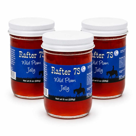 Three jars of Rafter 7S Wild Plum Jelly on a white background
