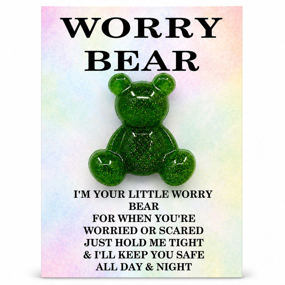 Green glittery bear toy on a colorful card with text