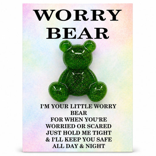 Green glittery bear toy on a colorful card with text