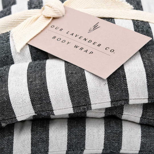 Black and white striped towel with a tag from 'Our Lavender Co.' on a checkered background
