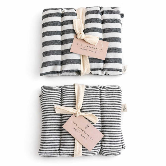 Two striped body wraps with ribbons and tags on a white background