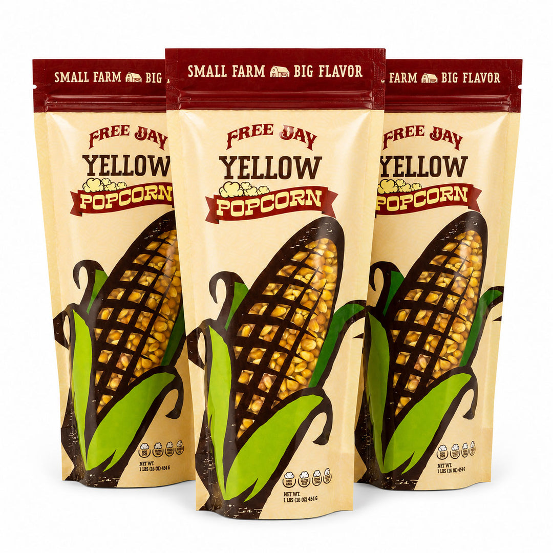 Three bags of Free Day Yellow Popcorn with corn illustrations on a white background