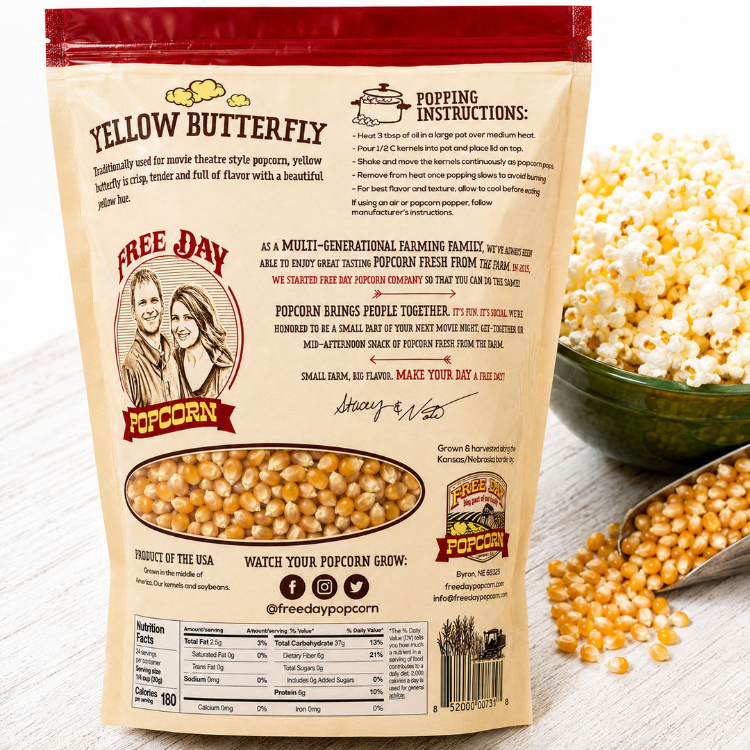 Free Day Popcorn bag with popping instructions and a bowl of popcorn on a wooden surface.