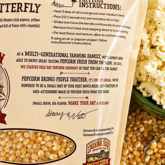 Free Day Popcorn bag with text and popcorn kernels, featuring a bowl of popcorn.