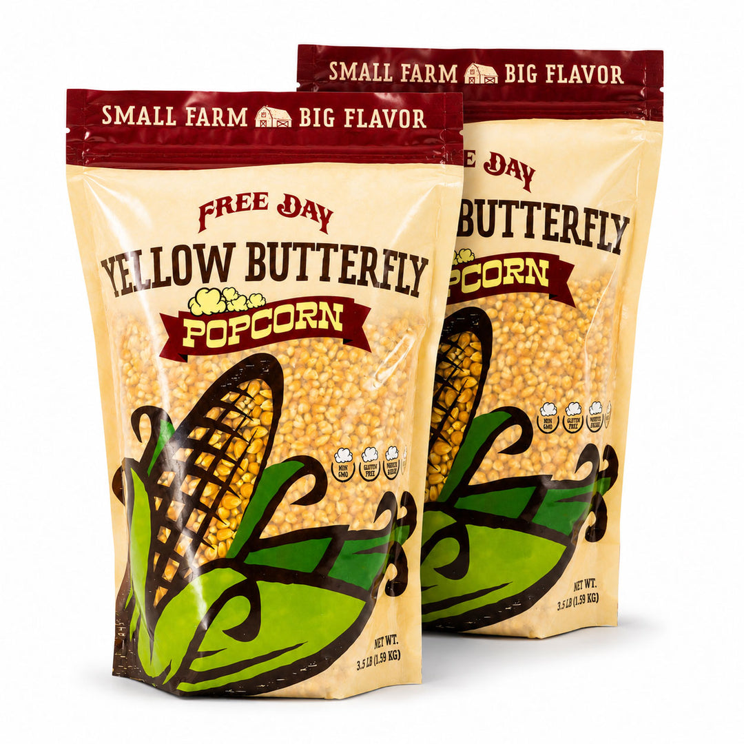 Two packages of Free Day Yellow Butterfly Popcorn on a white background
