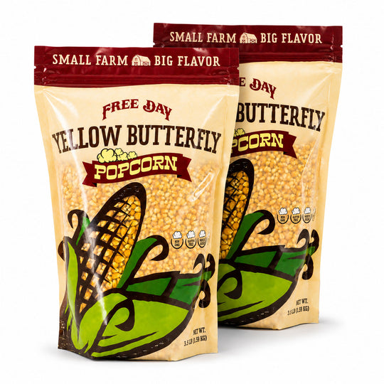 Two packages of Free Day Yellow Butterfly Popcorn on a white background