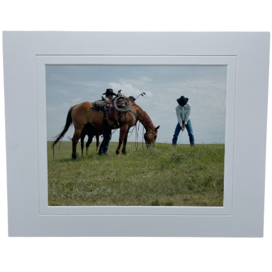  Photograph Of Two Cowboys Playing Golf In A Field Alongside A Grazing Horse 