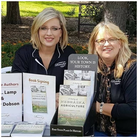 Image Of American Doorstep Project Employees Posed With A History Of Nebraska Agriculture: A Life Worth Living Book