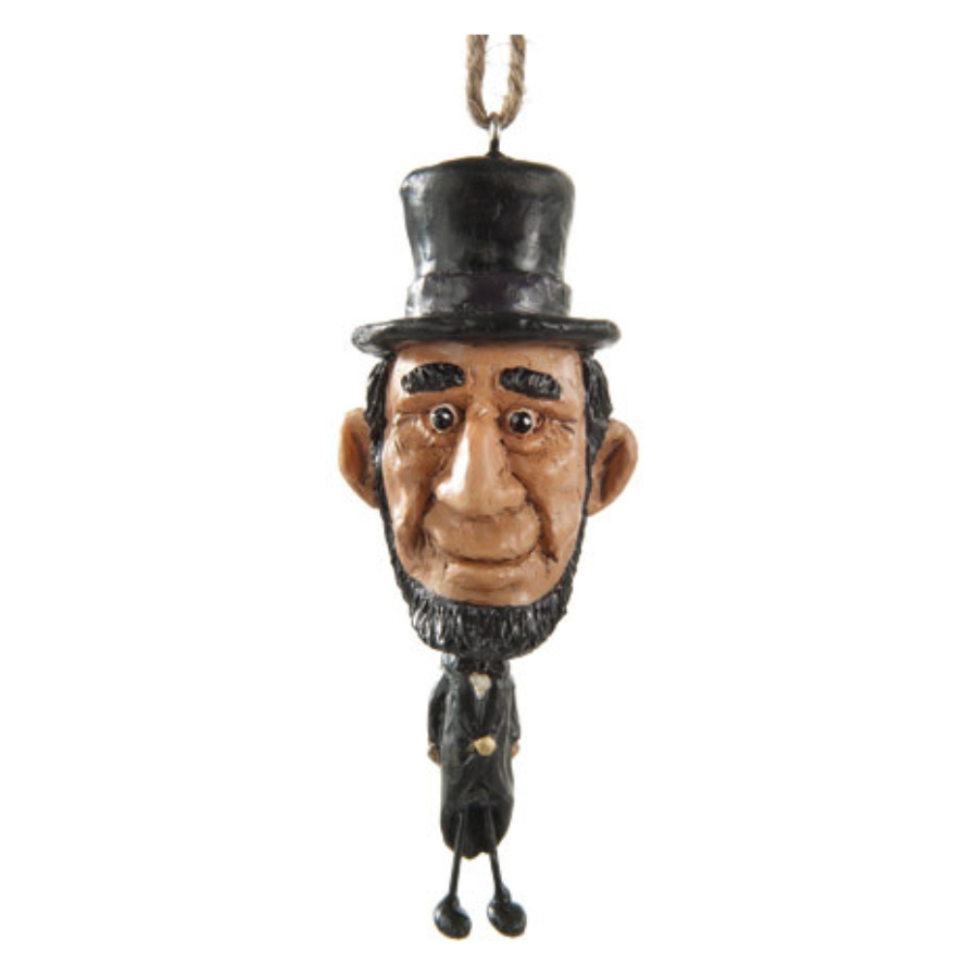 Abe Lincoln ornament with oversize head on a white background