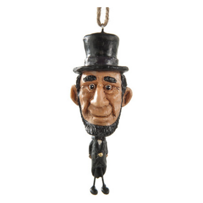 Abe Lincoln ornament with oversize head on a white background