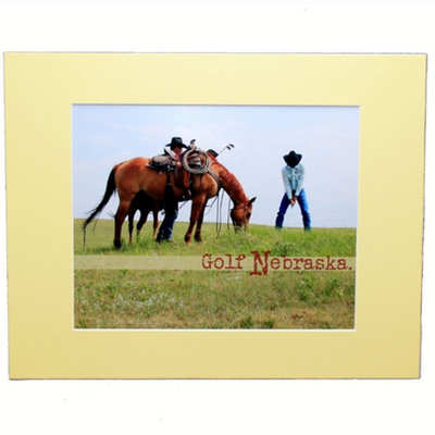 Photograph Of A Cowboy Golfing Next To A Horse With A Pale Yellow Border