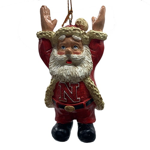 Santa ornament showing a University of Nebraska letter N on shirt worn under Santa coat. Arms are stretched up signaling a football touchdown, shown on a white background