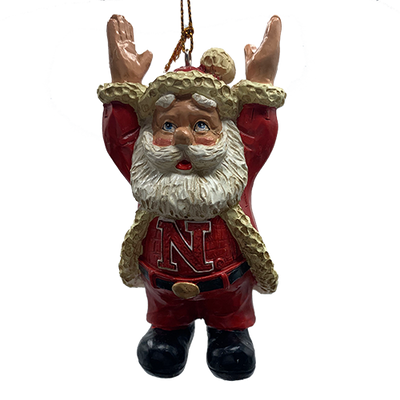 Santa ornament showing a University of Nebraska letter N on shirt worn under Santa coat. Arms are stretched up signaling a football touchdown, shown on a white background